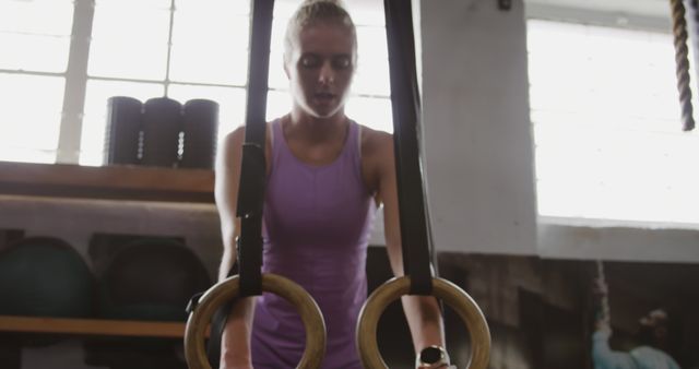 Focused Woman Training with Gymnastic Rings in Indoor Gym - Download Free Stock Images Pikwizard.com