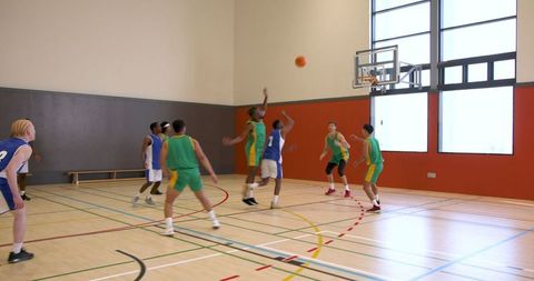 Energetic Youth Basketball Game in Indoor Gymnasium