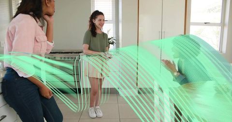 Friends chatting in modern kitchen with teal motion light trails and casual weekend style