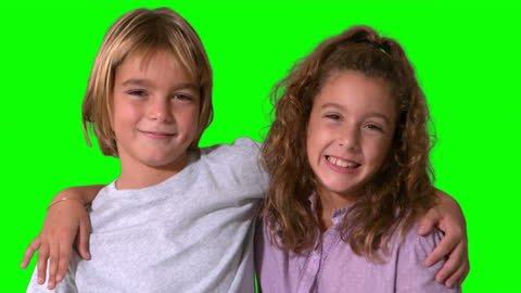 Happy Siblings Smiling with Green Screen Background