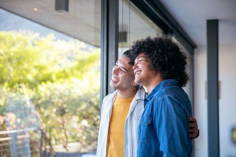Happy Couple Embracing in Modern Home with Scenic View