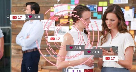 Women collaborating on tablet with sticky note board and social media overlays in office
