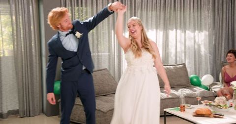 Joyful Newlyweds Dancing at Intimate Wedding Reception