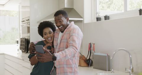Happy Couple Taking Selfie in Bright Modern Kitchen