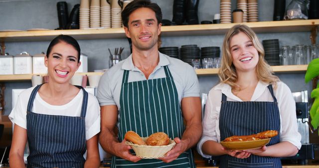 Smiling Bakery Staff Holding Freshly Baked Bread and Pastries - Download Free Stock Images Pikwizard.com