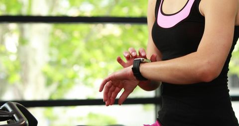 Woman Using Smartwatch at Gym During Fitness Workout
