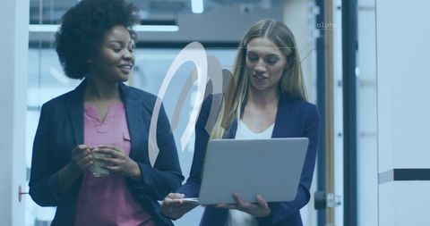 Businesswomen Collaborating on Digital Project in Modern Office