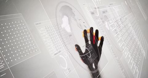 Pressing gloved hand interacting with futuristic hud and colored fingertip sensors