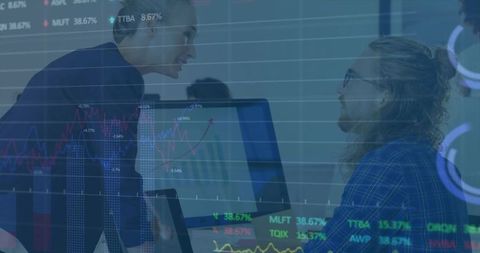 Colleagues analyzing stock market trends in office