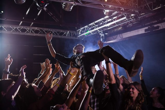 Crowd surfing at a concert in nightclub