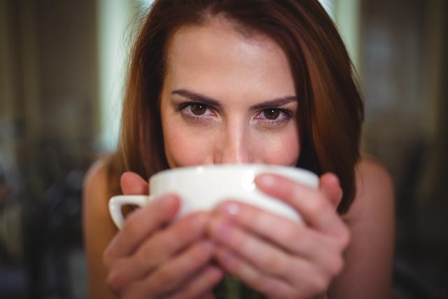 Portrait of beautiful woman having a cup of coffee in cafÃ©