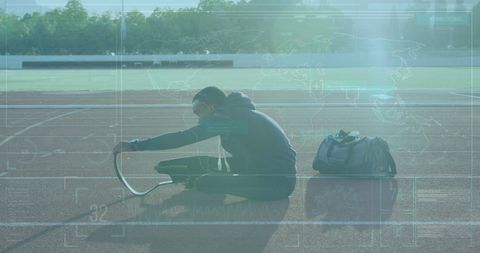 Disabled Athlete Analyzing Data on Track