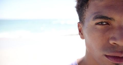 Young Man Gazing at Ocean on Bright Sunny Beach - Download Free Stock Images Pikwizard.com