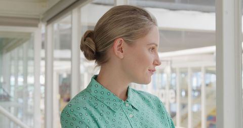 Contemplative Woman in Bright Office Environment