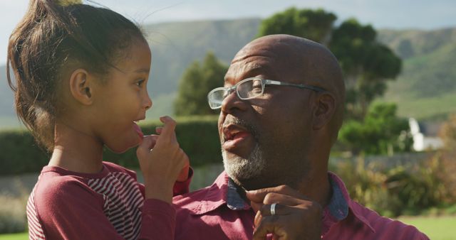 Grandfather and Granddaughter Enjoying Outdoors on Sunny Day - Download Free Stock Images Pikwizard.com