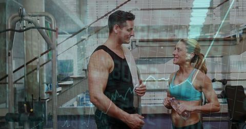 Personal trainer coaching female client at gym cable machine, fitness coaching session