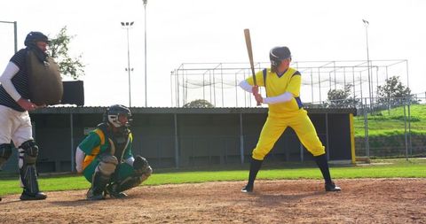 Dynamic baseball game with diverse players on sunlit field