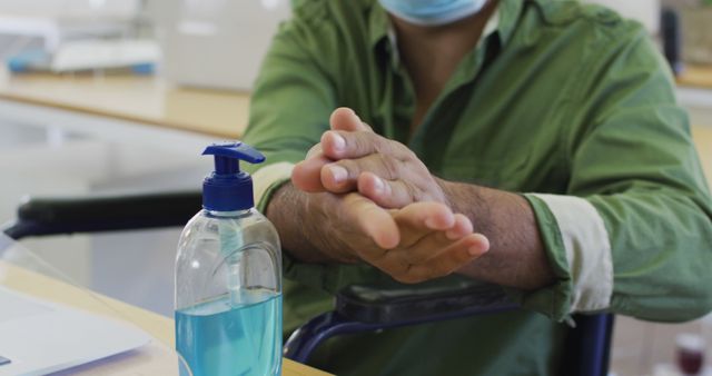 Person Sanitizing Hands While Sitting In Wheelchair - Download Free Stock Images Pikwizard.com