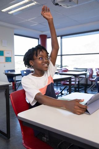 African American Student Raising Hand in Modern Classroom