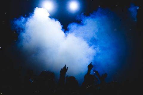Energetic nightclub scene with dancing crowd and smoking effects