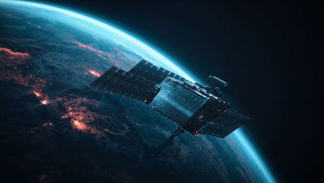 Satellite orbiting earth with solar panels capturing cosmic glow