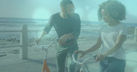 Couple on Seaside Promenade with Bicycles at Sunset