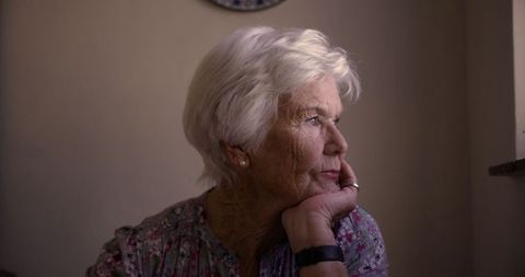 Senior Woman Reflecting in Soft Light at Home