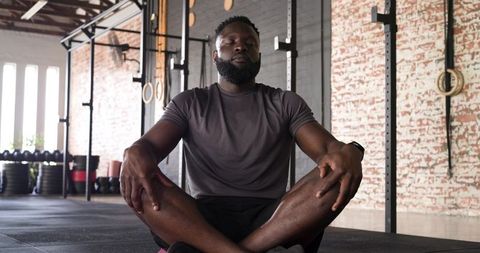 African American Man Meditating in Urban Fitness Studio