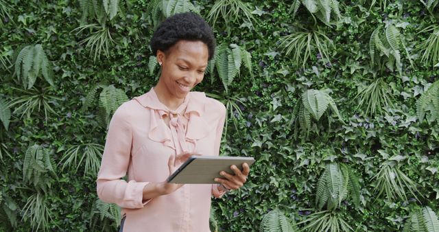 Smiling Woman Using Digital Tablet Against Greenery Backdrop - Download Free Stock Images Pikwizard.com