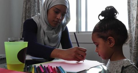 Mother and Daughter Bonding Over Coloring at Home