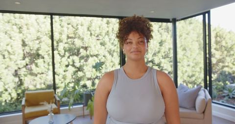 Confident Young Woman in Bright Modern Living Room