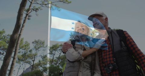 Senior Couple Exploring Forest with Honduras Flag in Background