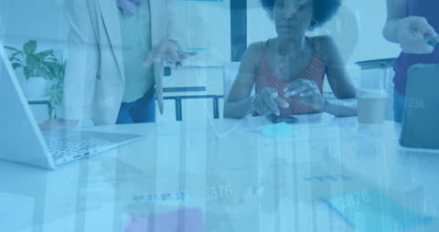 Multi-Ethnic Team Analyzing Financial Data in Modern Office