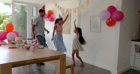 Family Celebrating Birthday at Home with Joy and Festive Decorations