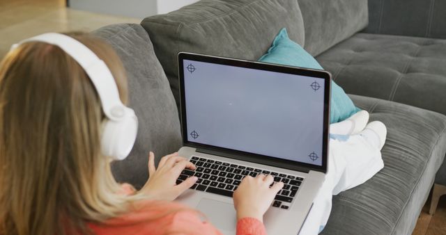 Woman Using Laptop with Headphones on Couch for Entertainment - Download Free Stock Images Pikwizard.com