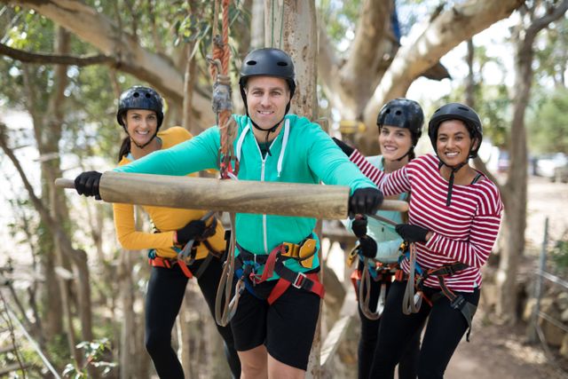 Group of friends enjoying a zip line adventure in a park. They are wearing helmets and safety gear, smiling and ready for an exciting ride. Perfect for promoting outdoor activities, team-building events, and recreational adventures.
