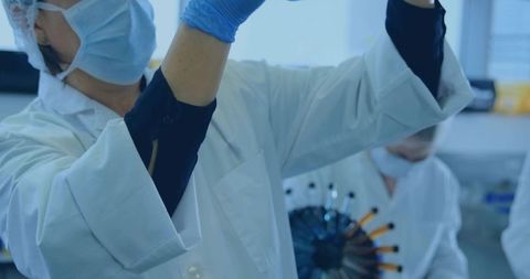 Lab Technician Examining Vial in Scientific Research Laboratory