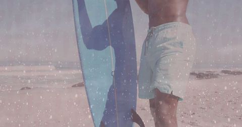 Surfer Holding Blue Surfboard on Sandy Beach Adventure