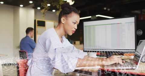 Focused businesswoman analyzing data spreadsheet at workspace