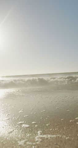 Tranquil Seashore with Gentle Waves Under Bright Sunlight - Download Free Stock Images Pikwizard.com