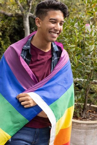 Pride and Happiness: Young Hispanic Man Embracing Diversity Outdoors