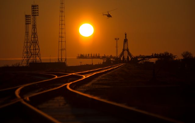 A security helicopter is seen surveying the launch pad area ahead of the Soyuz TMA-16M spacecraft arrival by train, Wednesday, March 25, 2015, Baikonur Cosmodrome, Kazakhstan. NASA Astronaut Scott Kelly, and Russian Cosmonauts Mikhail Kornienko, and Gennady Padalka of the Russian Federal Space Agency (Roscosmos) are scheduled to launch to the International Space Station in the Soyuz TMA-16M spacecraft from the Baikonur Cosmodrome in Kazakhstan March 28, Kazakh time (March 27 Eastern time.) As the one-year crew, Kelly and Kornienko will return to Earth on Soyuz TMA-18M in March 2016.  Photo Credit (NASA/Bill Ingalls)