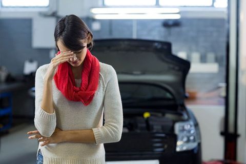 stressed woman facing car trouble in repair garage - Download Free Stock Images Pikwizard.com