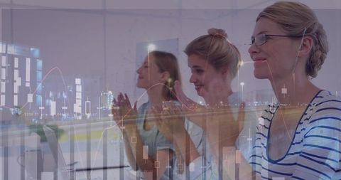 Businesswomen Applauding with Financial Graph Overlay
