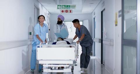 Medical Team Rushing Patient on Gurney in Hospital Hallway - Download Free Stock Images Pikwizard.com