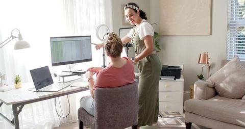 Two Female Colleagues Collaborating Creatively at Home Office