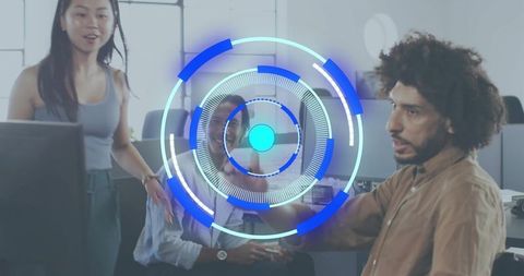 Collaborating team in modern open-plan office with futuristic blue HUD overlay and screens