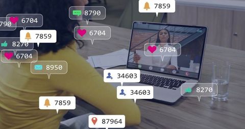 Woman attending online meeting while laptop displaying social engagement notifications and metrics
