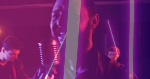 Lead vocalist singing into vintage ribbon mic under neon magenta and purple lights
