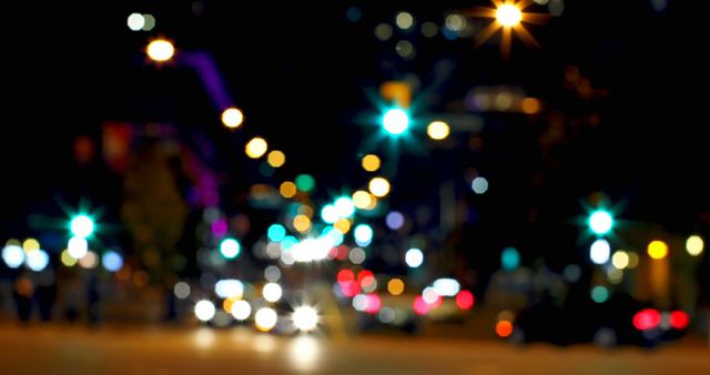 Scene showing city road at night characterized by vividly defocused, glowing streetlights and vehicle headlights resulting in beautiful bokeh effect. Perfect for using in digital backgrounds, travel advertisements, urban studies, or billboard designs emphasizing nighttime city life and illumination.